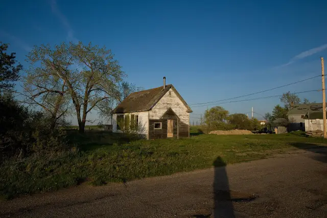 Old white building on a gravel road